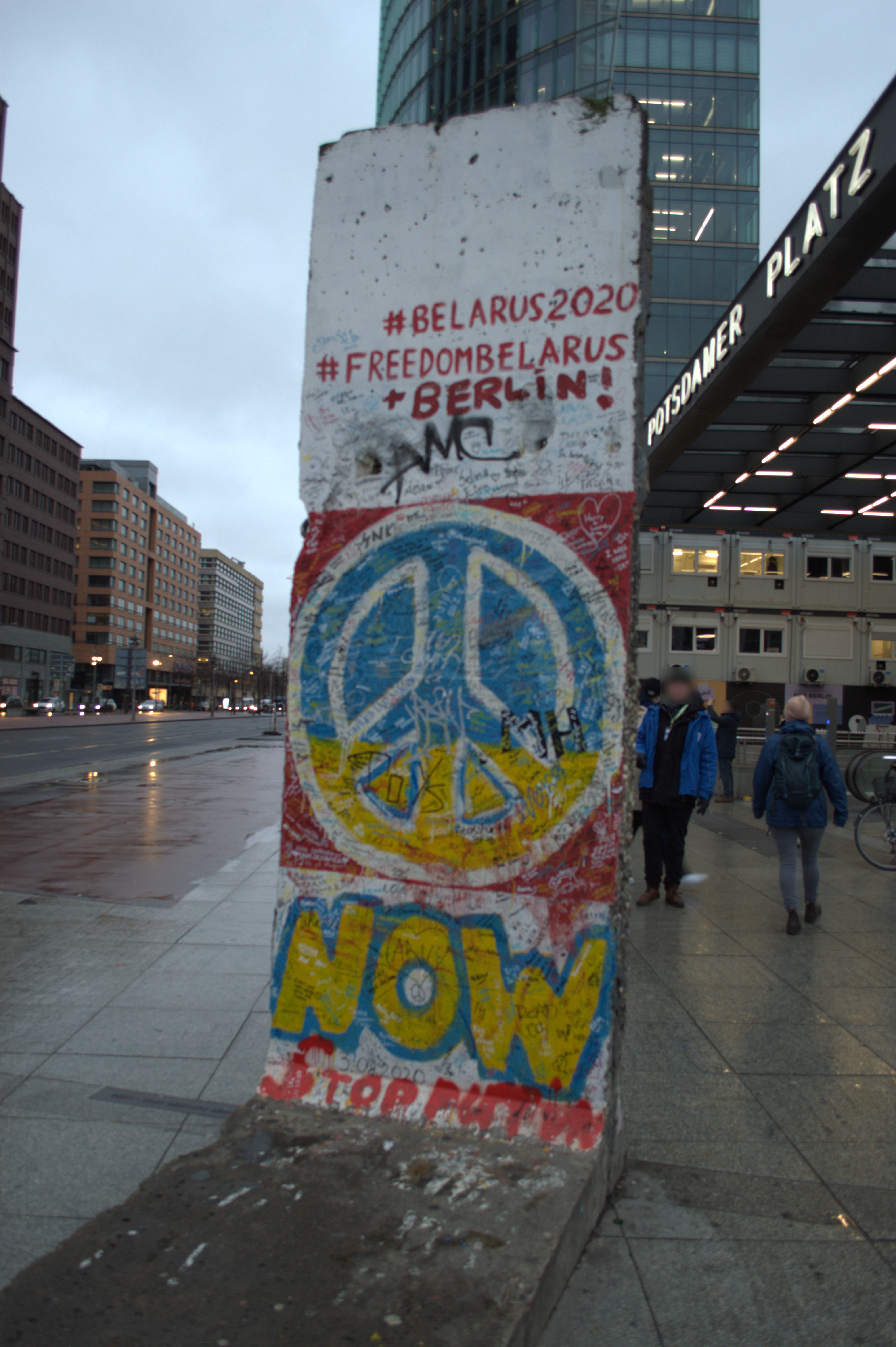 Photo of a piece of the Berlin Wall showing graffiti related to the currently political landscape of the world in 2023