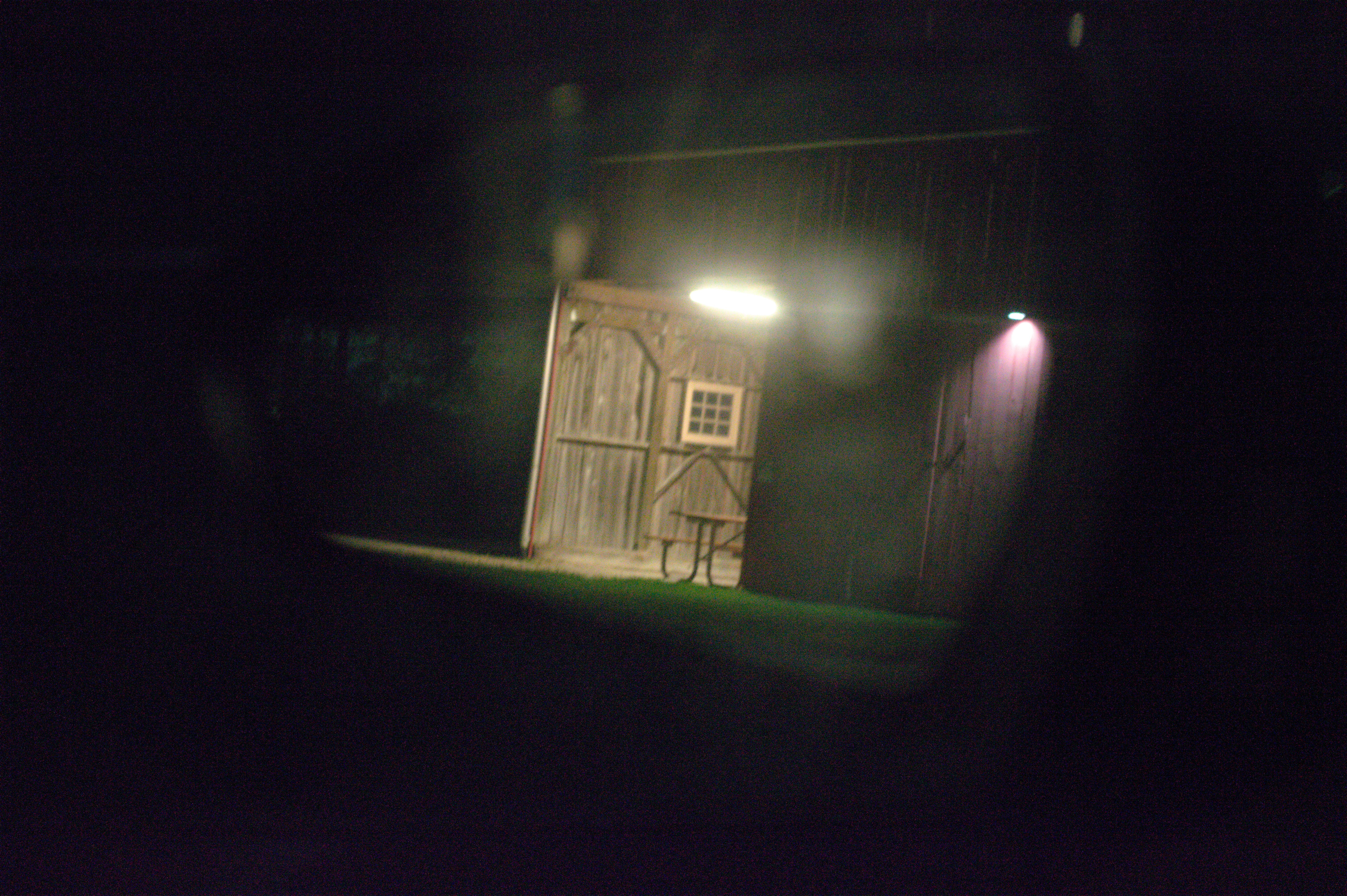 Photo of a barn as see through a car's side view mirror